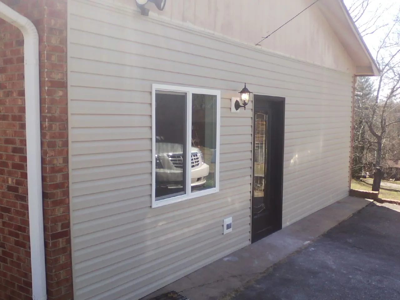 New vinyl siding and entry door on a room addition in Maidsville